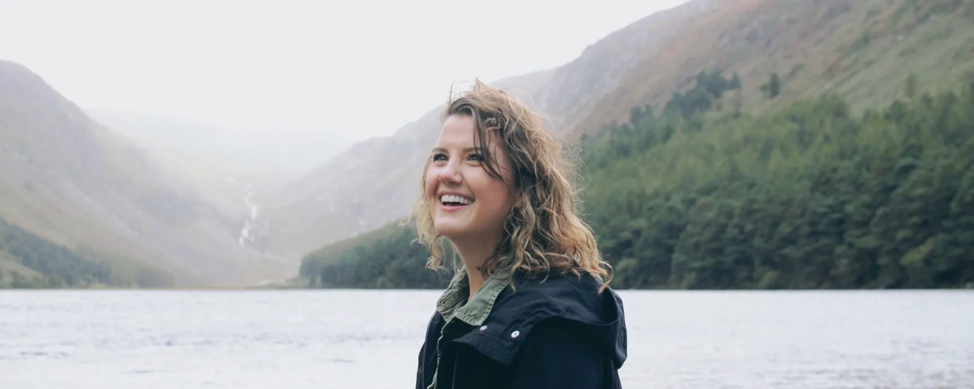 smiling-woman-glendalough-lake-co-wicklow-ireland-newway.webp